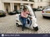 sir-stirling-moss-with-his-electric-scooter-in-london-DRNCDX.jpg