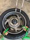 BFG car tire mouting with 2x4 and ratchet straps to hold bead down in center IMG_4285.jpeg